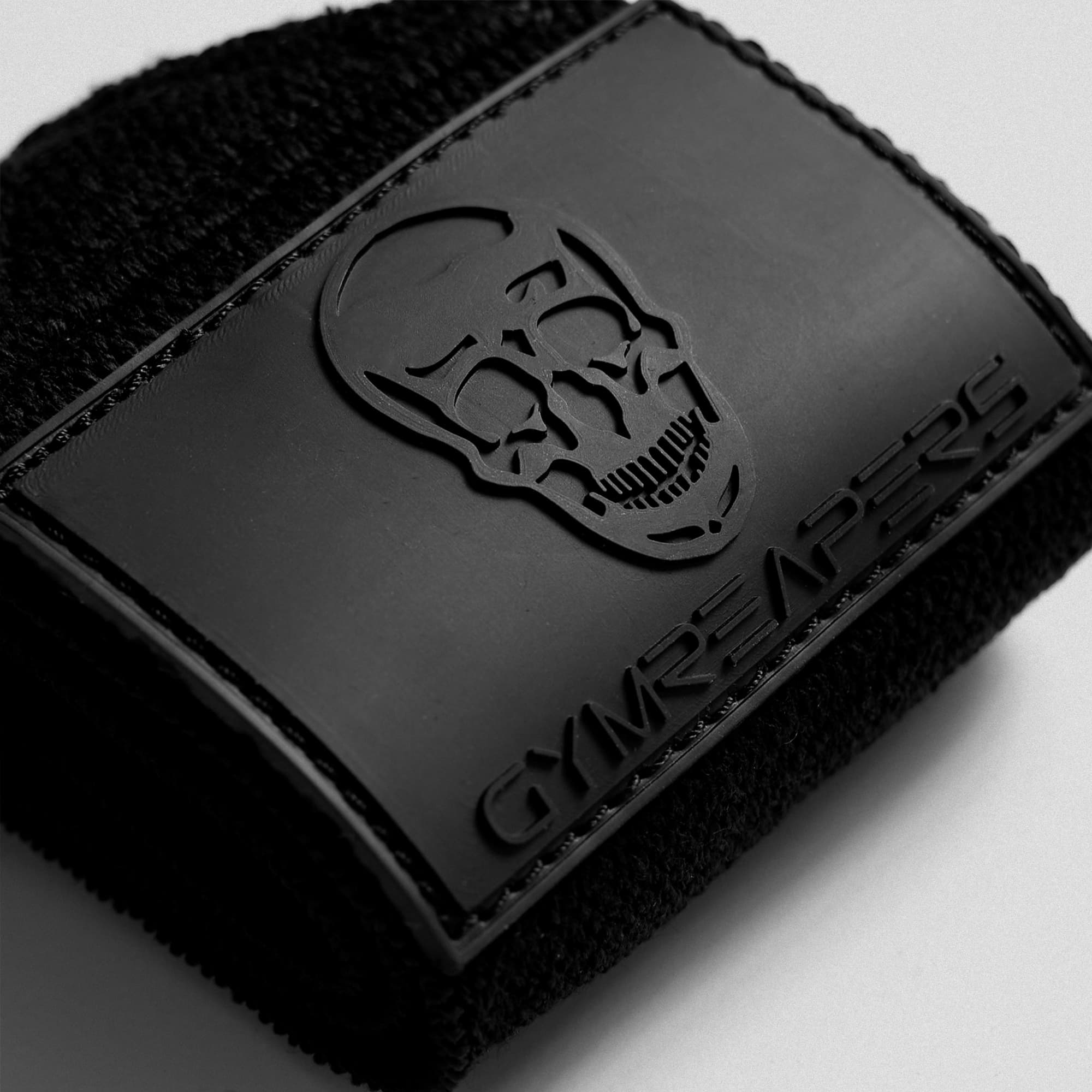 Close up shot of logo on black/rubber wrist wraps.